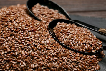 Spoons with flax seeds on table, closeup