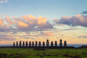 Dramatic colorful sunrise over Moai stone sculptures at Ahu Tongariki, Easter island, Chile.