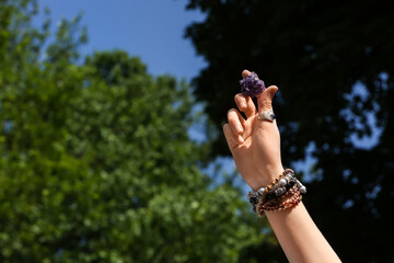 Woman with beautiful amethyst outdoors