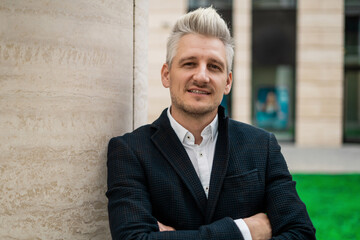 Portrait of a gray-haired economist man looking at the camera in a business suit