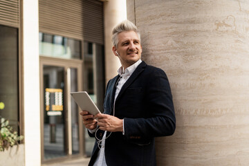 The manager responds to clients ' emails. Portrait of a male economist holding a gadget in his hands. A banker in a business suit surf the Internet.