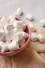 Bowl with tasty marshmallows on light background, closeup