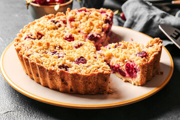 Plate with tasty cherry pie on dark background, closeup