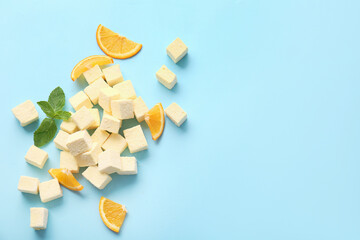 Tasty sweet marshmallows, orange and mint on color background