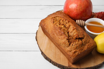 Bread with honey and fruits on white wooden background. Rosh hashanah (Jewish New Year) celebration