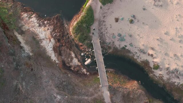 Aerial: Hiking path, bridge and lake in Abbotts Lagoon. Point Reyes, California, USA