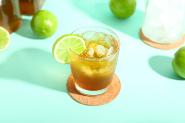 Glass of tasty Long Island iced tea on color background