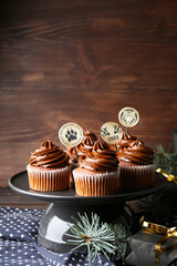 Dessert stand with tasty cupcakes for New Year 2022 celebration on table
