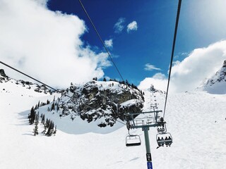 Low Angle View Of Ski Lift Against Snowcapped Mountain