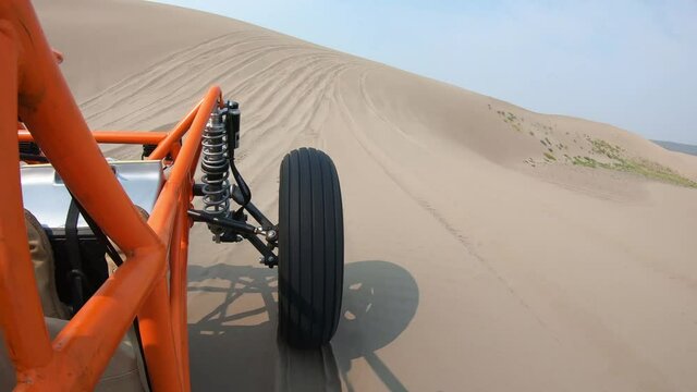 Orange Dune Buggy Driving in the Sand Dunes