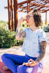 Woman doing yoga breath work practice outside 