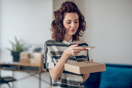 Woman scanning the QR code on the package