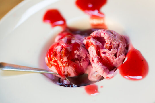 Delicious ice cream with berry jam and candied fruits..