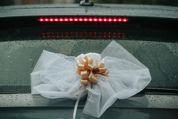wedding decoration on the back of the car rainy day