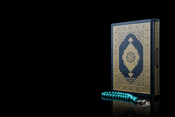 Islamic concept - The Holy Al Quran with written Arabic calligraphy meaning of Al Quran and rosary...