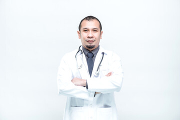 Portrait of cheerful smiling man doctor with arms crossed on white background.