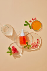 Glass petri dish and test tube with pomegranate and pomegrante seeds extract and serum bottle for mockup . Research and develop cosmetic production in the laboratory. Top view image