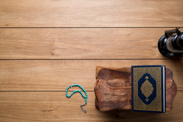 Islamic concept - The Holy Al Quran with written Arabic calligraphy meaning of Al Quran and rosary...
