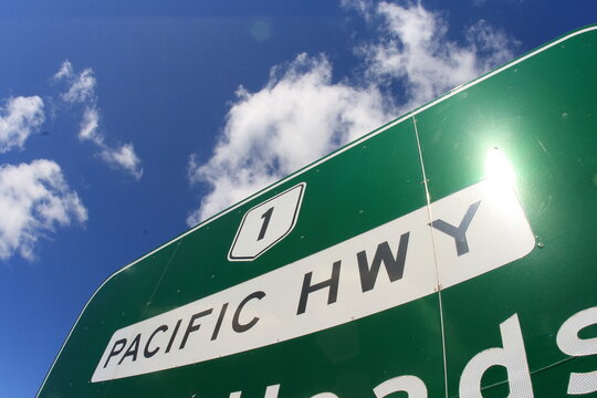 National Pacific Highway sign, Australia. With blue sky and clouds.