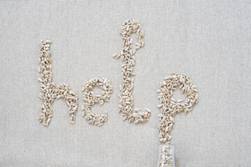 On a gray background, there are seeds in the form of letters and the word "help"