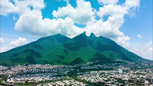 Amazing aerial drone hyperlapse of El Cerro de la Silla with moving clouds in Nuevo Leon, Mexico