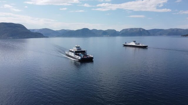 Ferry Mf Stavanger passing ferry Mf Oppedal in the middle of Sognefjorden in Vestland Norway - Norled company ferries at work along road E39 ferry crossing between Oppedal and Lavik