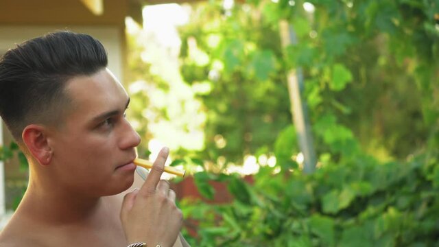 Closeup of Young Attractive Hispanic Teen Vaping Outdoors from Puff Bar