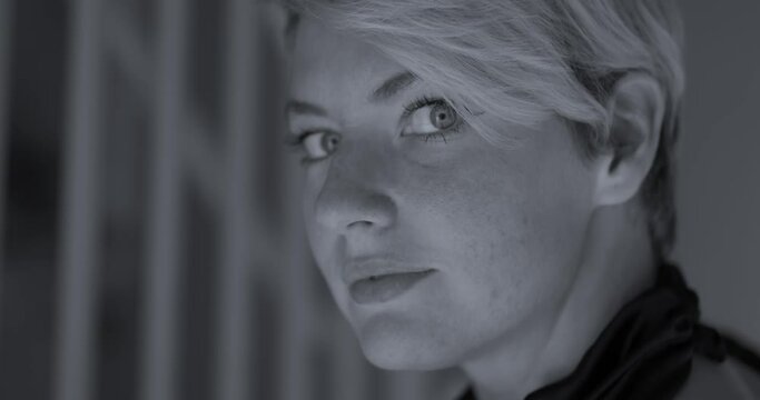 Incredible piercing eyes of the short blonde haired female super model in this black and white clip close up on her face with stairs in background. In Cinema 4K (4096x2160) 30fps slowed from 60fps.