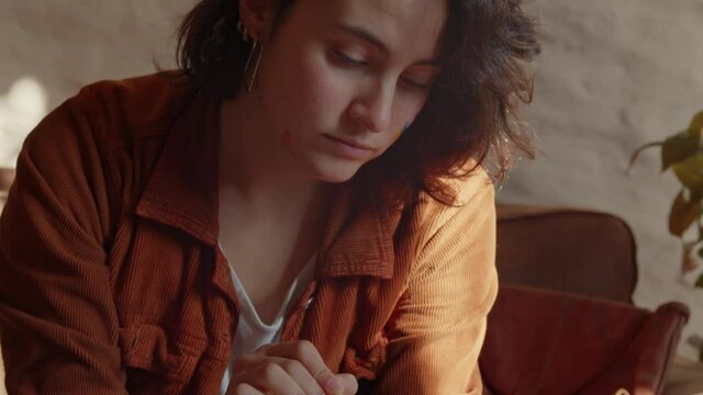 Designer latin woman working on an ipad at home, tilt down