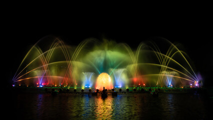 Fototapeta na wymiar The colorful fountain dancing in celebration festival with dark night sky background. 