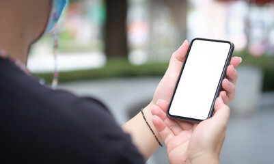 Cropped shot young man standing outdoor and using smart phone.