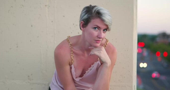 Super sexy scantily clad blonde women on rooftop balcony looking with come hither eyes into the camera, as she&rsquo;s lonely and flirting with the viewer. In Cinema 4K (4096x2160) 30fps slowed from 60fps.