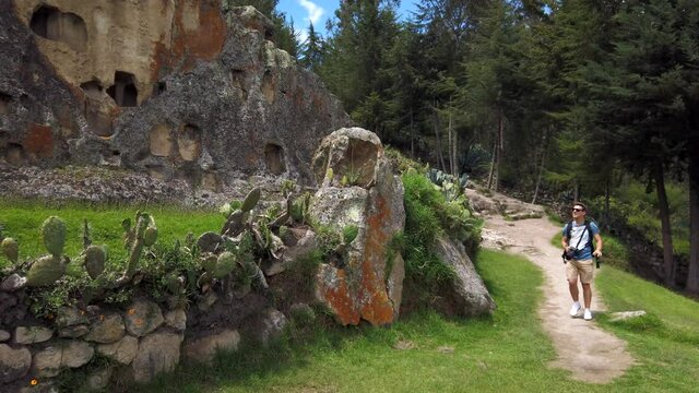 Nature Photographer Walking On The Trail At Ventanillas de Otuzco In Otuzco, Peru. dolly-out shot