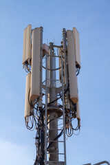 telecommunications tower of different mobile phone, radio and television operators with masts and microwave radio link antennas, 4g and deployment of 5g generation in cities and rural areas 