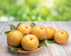 Fresh Snow pear fruit in Bamboo basket, Fresh Nashi pear fruit in the basket on wooden background.