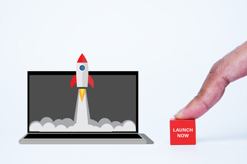 A picture of rocket launch from laptop with finger press launch now wooden block. New online...