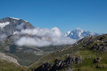 A summer mountain hiker on the summits in front of glaciers	