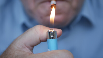 Smoker Lighting a Cigarette with a Gas Lighter. Close Up Shooting with a Person Smoking a Cigarette.