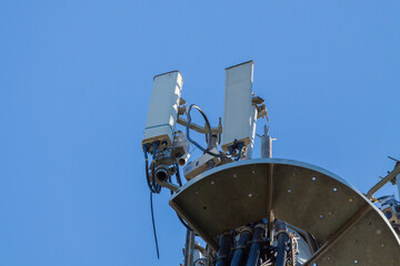 telecommunications tower of different mobile phone, radio and television operators with masts and microwave radio link antennas, 4g and deployment of 5g generation in cities and rural areas 