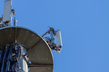 telecommunications tower of different mobile phone, radio and television operators with masts and microwave radio link antennas, 4g and deployment of 5g generation in cities and rural areas 