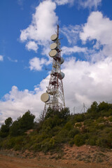 Obraz premium telecommunications tower of different mobile phone, radio and television operators with masts and microwave radio link antennas, 4g and deployment of 5g generation in cities and rural areas 