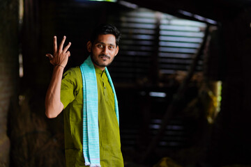 Indian farmer in traditional wear and giving happy expression at home