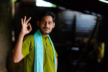 Indian farmer in traditional wear and giving happy expression at home