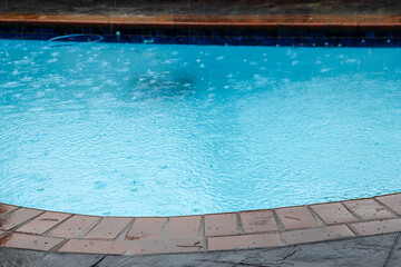 Fototapeta na wymiar rain falling in swimming pool