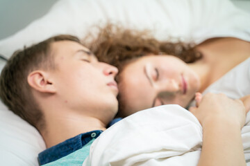 Obraz na płótnie Canvas Couple sleep in morning on white bed cozy room