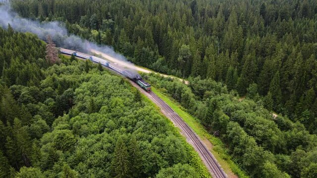 old diesel train moving along the railway lane beautiful scenery forest mountains