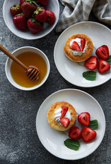 Fototapeta na wymiar Cottage cheese pancakes, ricotta fritters on ceramic plate with fresh strawberry.