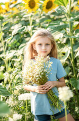 Beautiful little girl in sunflowers