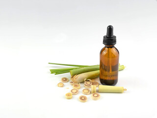 Lemongrass with leaves and essential oils in a bottle, isolated on white background.