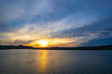 Sunrise waterscape with soft high cloud cover